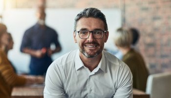 a smiling man with glasses