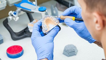 Dental lab technician working on dentures