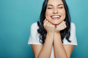 Woman smiling happily after her full mouth reconstruction 